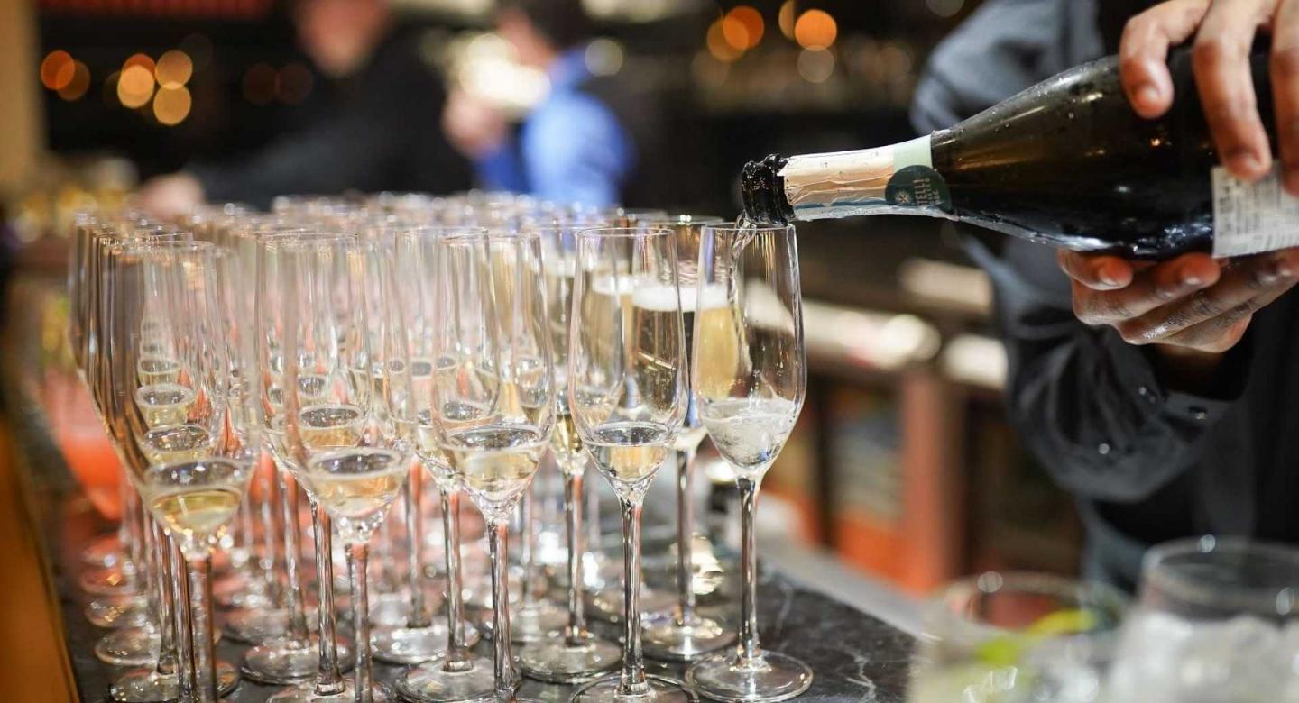 Glasses being filled with sparkling wine